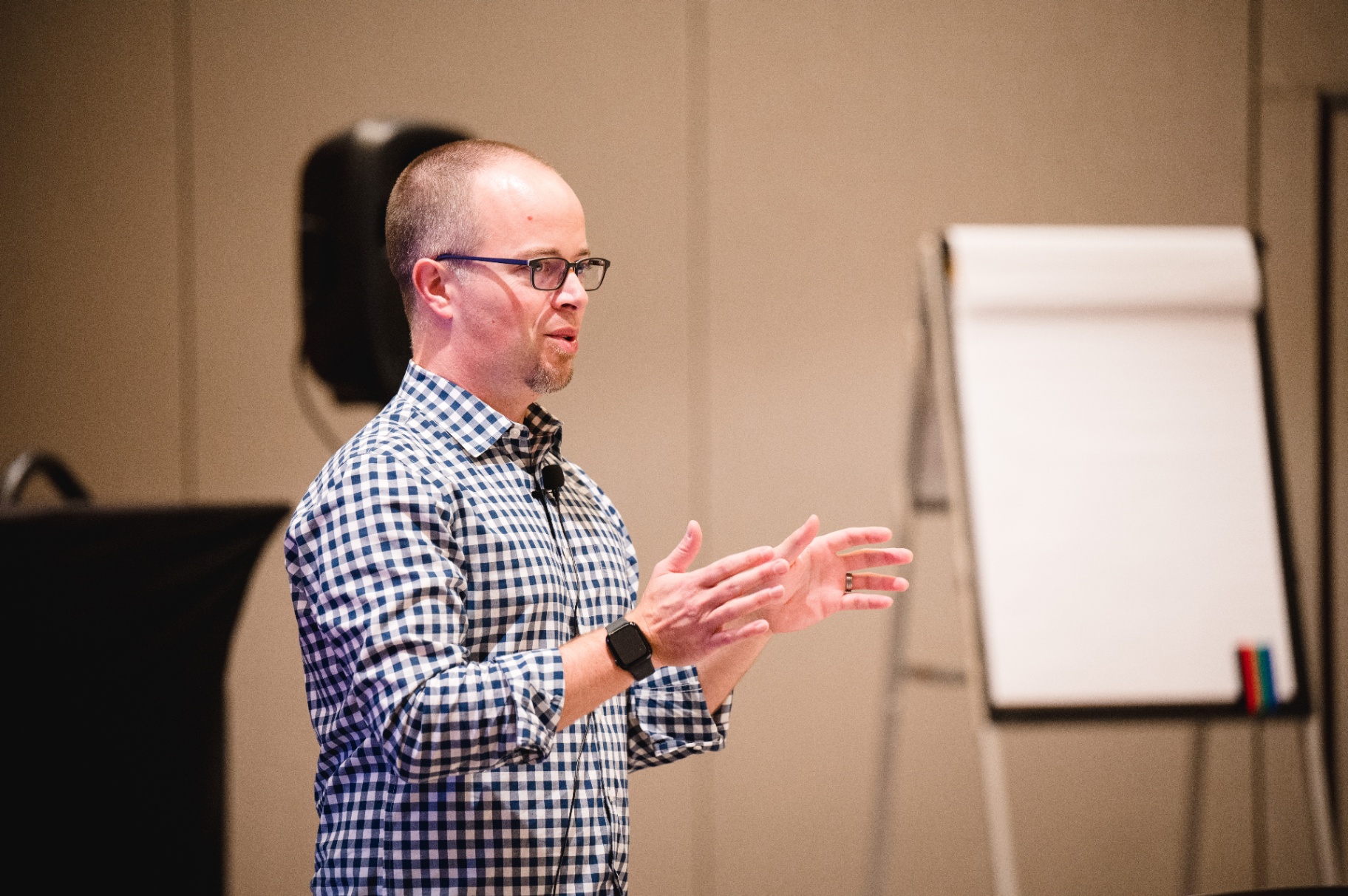 Aaron Lee teaching a leadership session, hands framed as he explains a concept